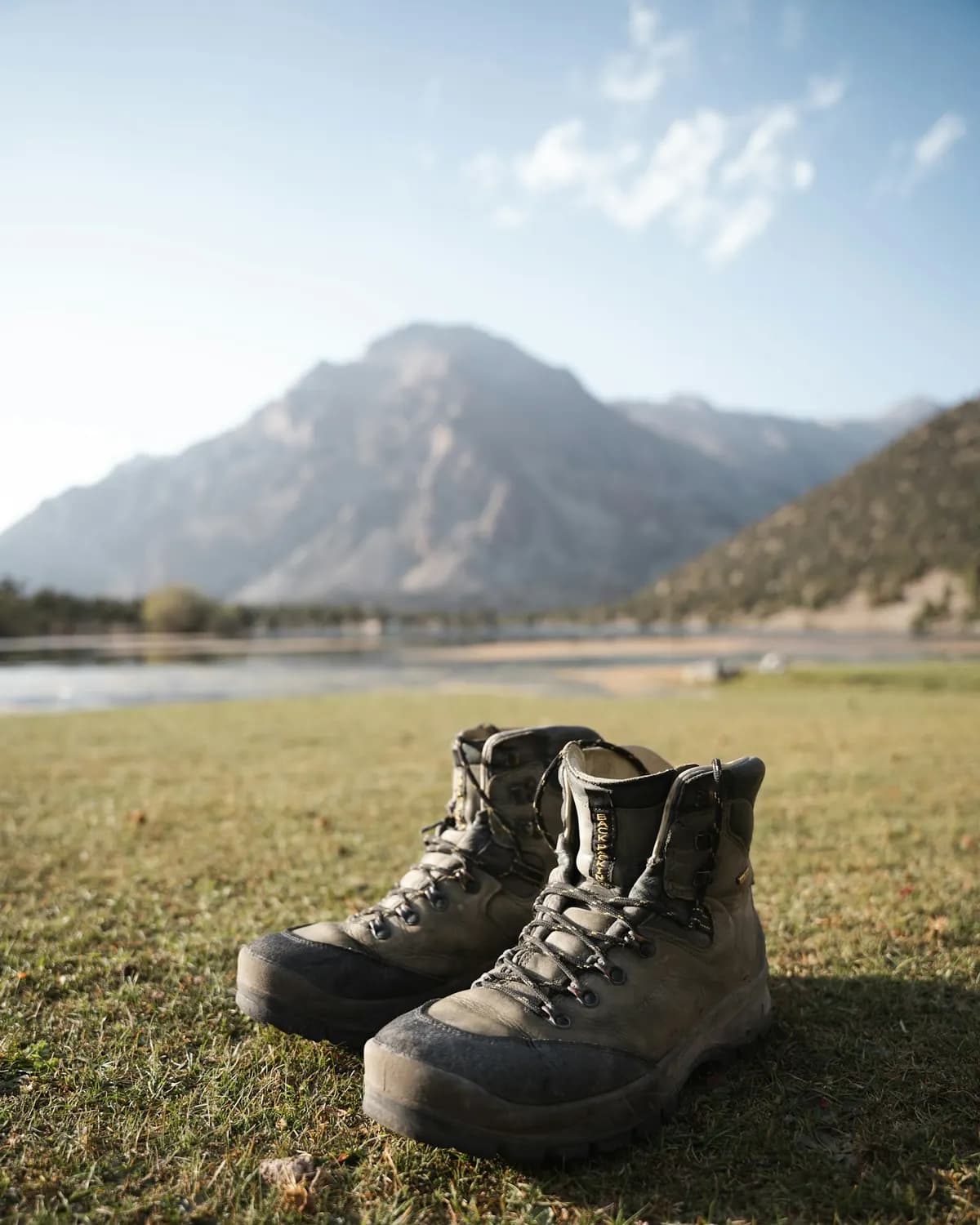 Farmer's boots on a field track between crop rows, no face
